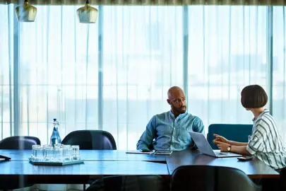 two people in a meeting room