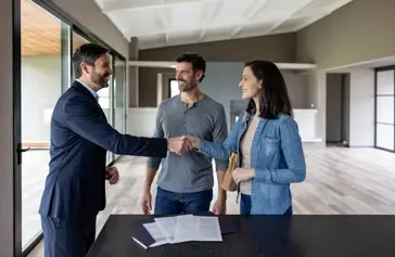 three people making a deal