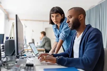 Two people looking at a screen