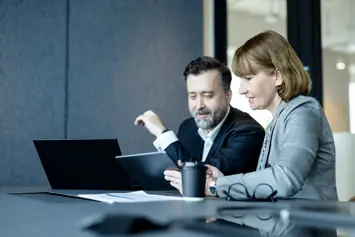 Two people working at a desk