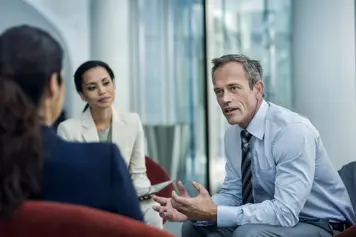 three people talking