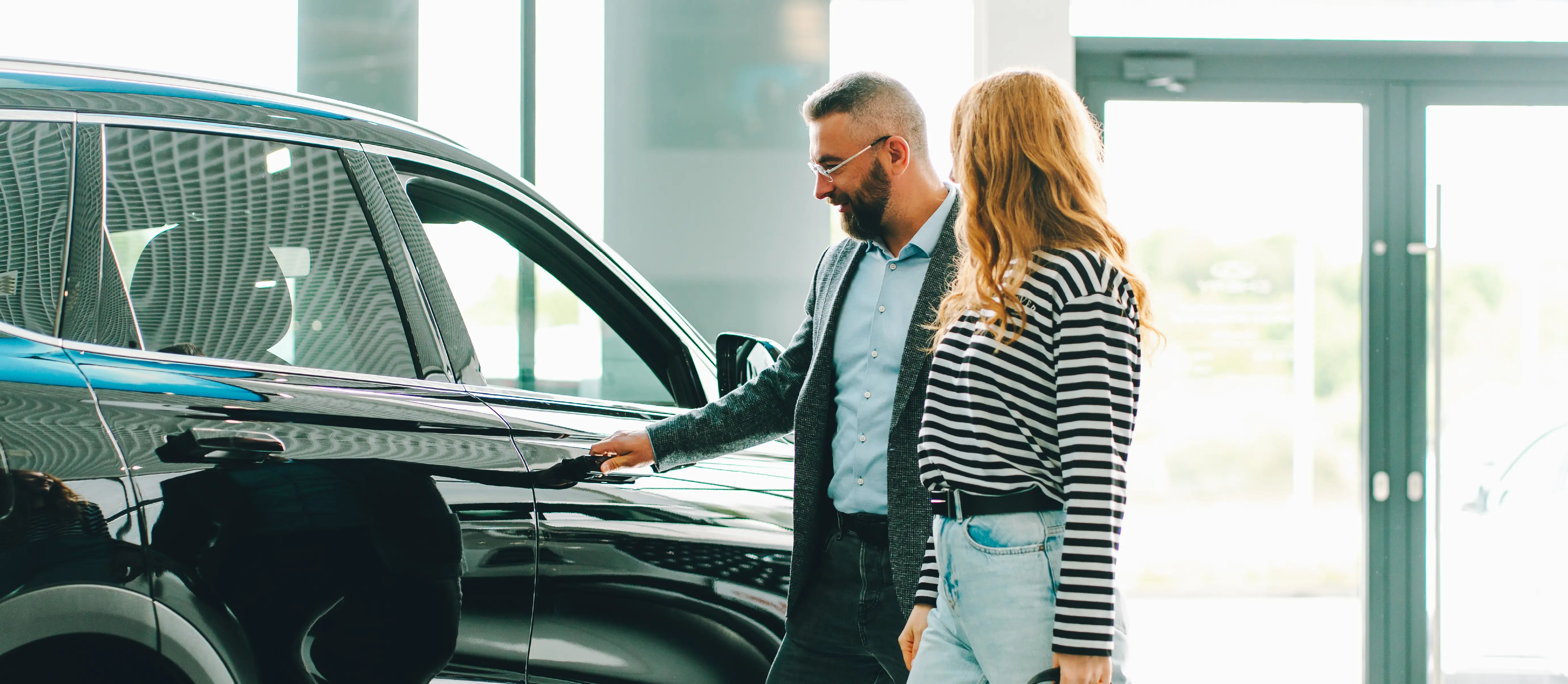 People in a car showroom