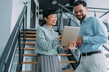 Two people looking at a tablet