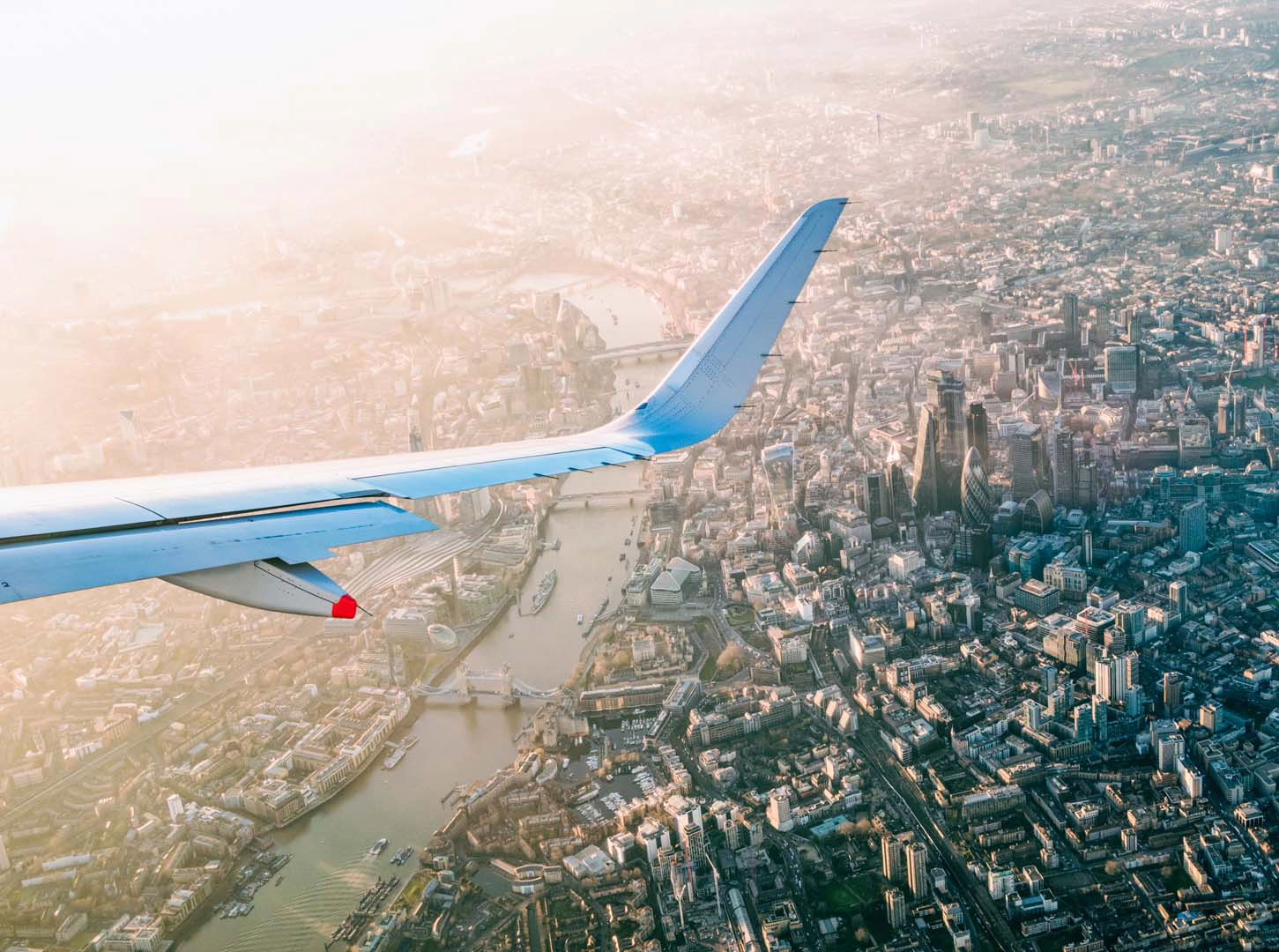A plane wing over city