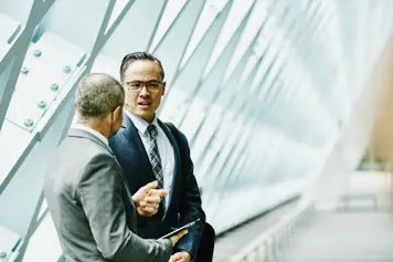 two people talking in an office building