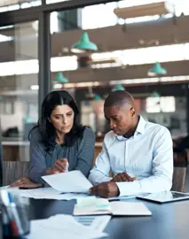 two people looking at a document