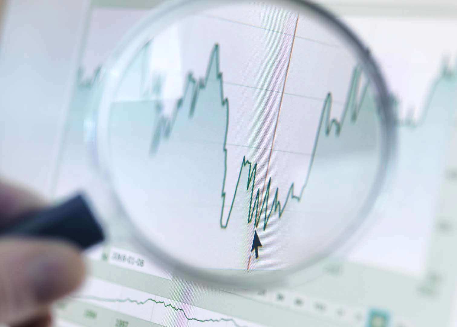 A magnifying glass examining a graph