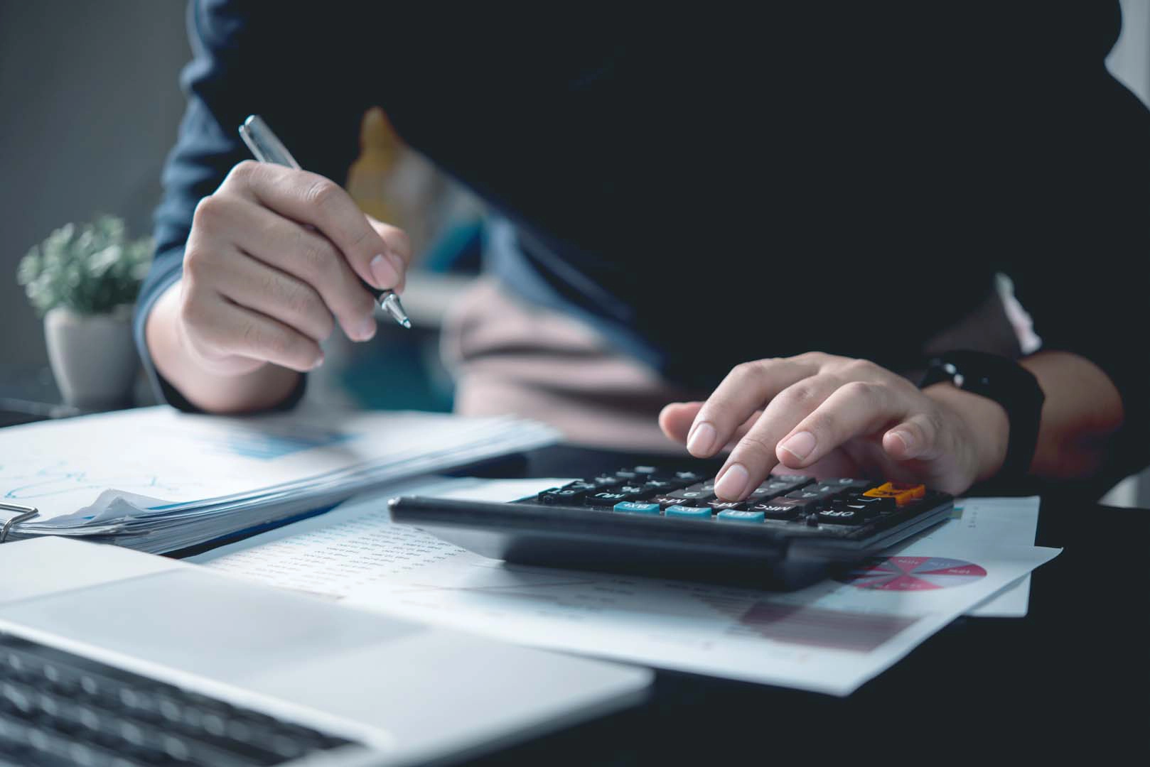 Person using calculator on desk