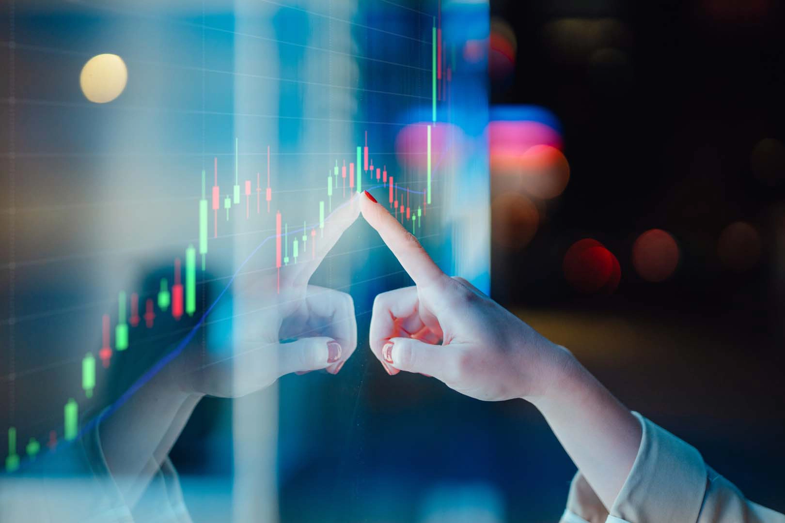 Women's hand on screen showing graph