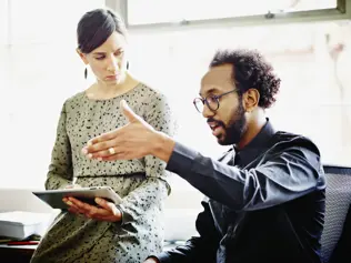 two people discussing in an office
