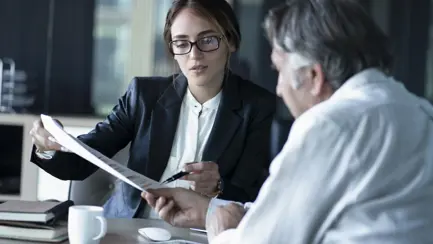 two people reviewing a document